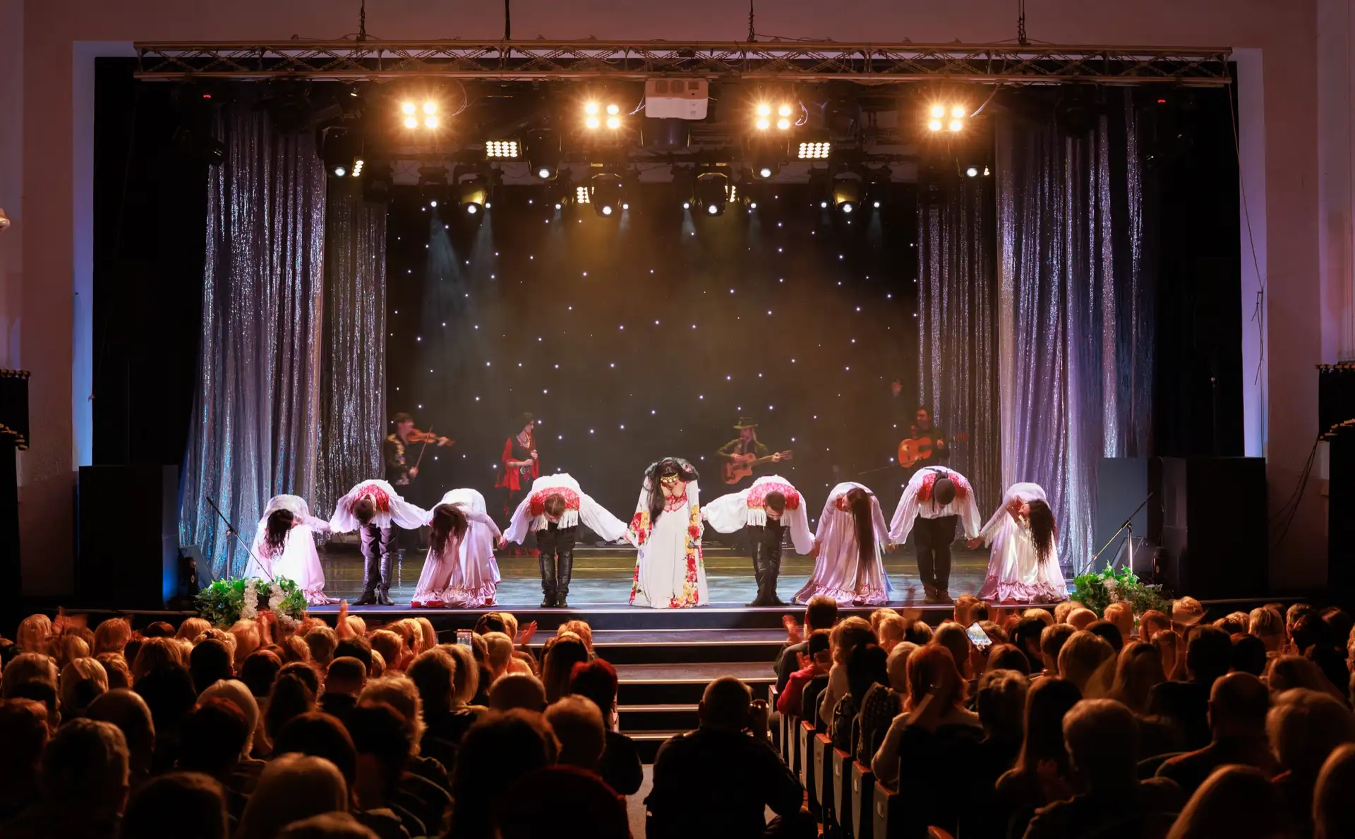 Dancers performing on stage for an audience at an American Spirit Network event